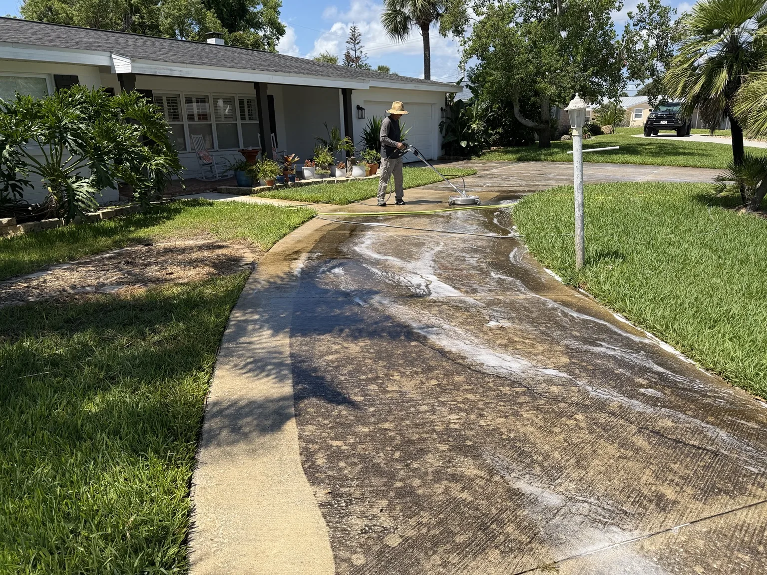 Professional driveway pressure washing in progress